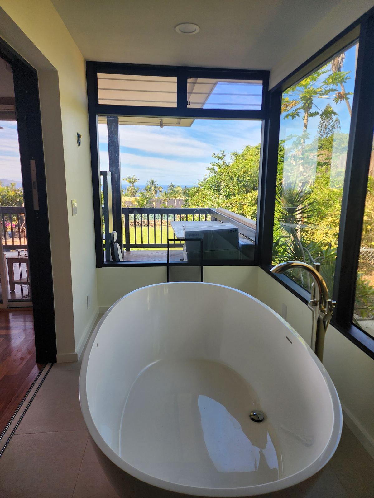 Finished custom bathroom with a freestanding tub and window view